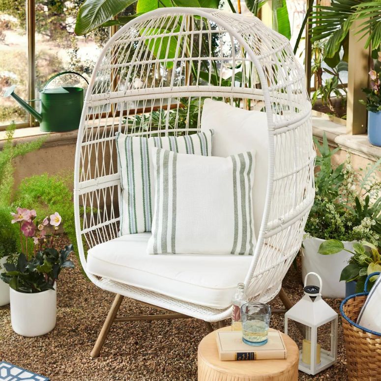 White rattan egg chair on a porch