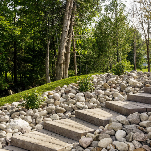 A tidy front yard walkway lined with stones
