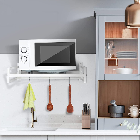 Wall-mounted microwave shelf in a tidy kitchen