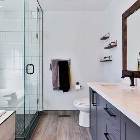 A bright, modern white bathroom with a spacious walk-in shower and a double vanity
