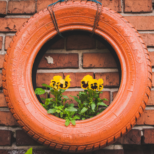 A vintage orange tire made into an upcycled planter