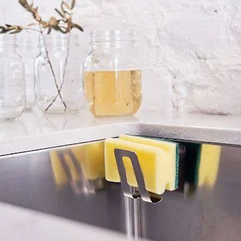 A charcoal sponge caddy mounted to the inside of a sink