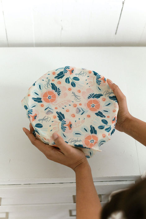 Amy Hall founder of Goldilocks Goods presses one of her pretty beeswax wraps onto a bowl on a kitchen counter