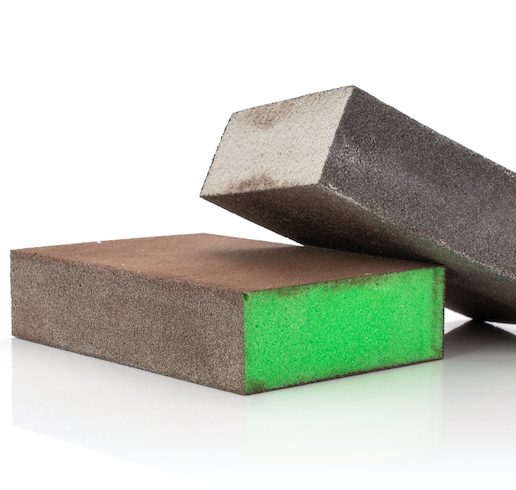 Group of two whole grey and green abrasive block sponges work sanding sponge isolated on white background as part of a painting kit essential tools