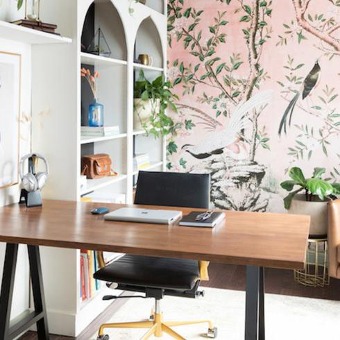 Office with bird wallpaper and wooden desk