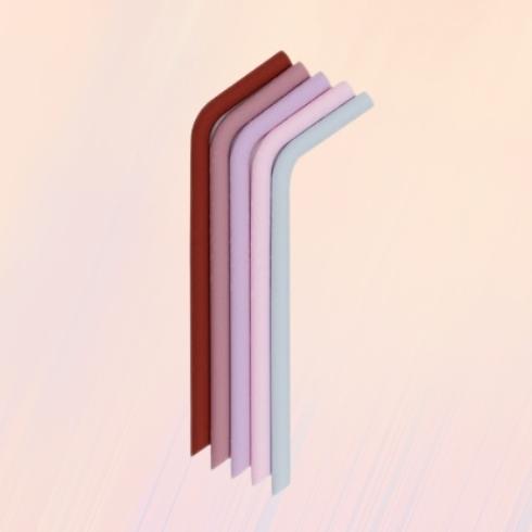 Silicone reusable straws in different shades of pink in a peach background