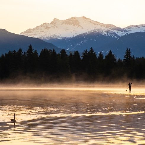 Man paddle boarding on alta lake at sunrise
