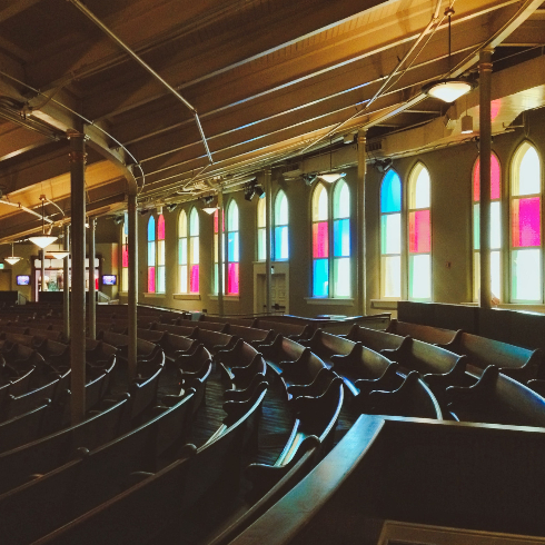 The interior of the Ryman Auditorium with stained glass windows
