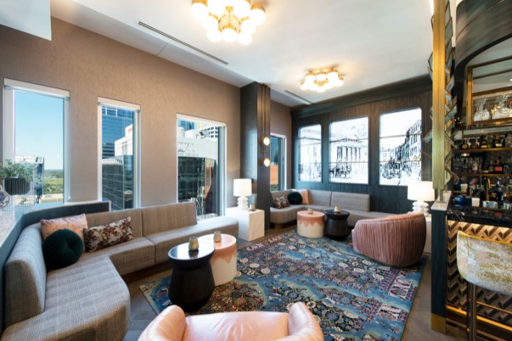 Lounge with chairs, patterned carper and views of the city