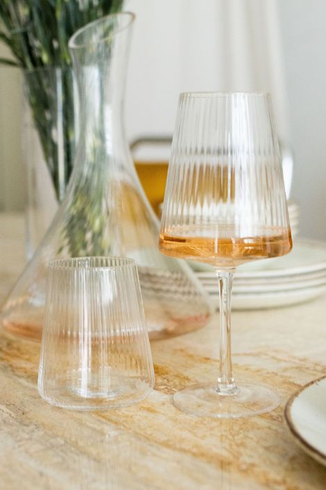 Wine glasses and a decanter on a wooden table