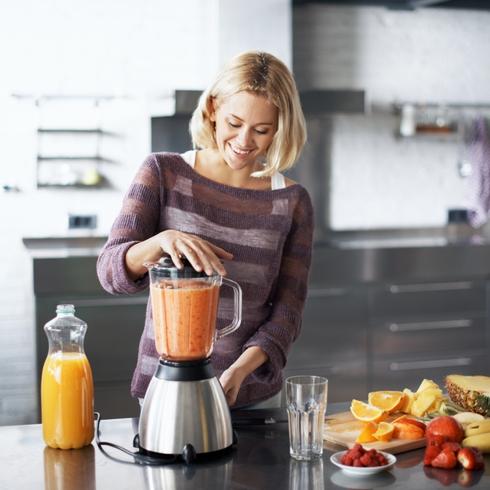 Woman making a smoothie at home