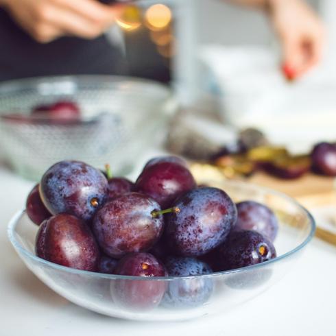 Plums in a glass bowl