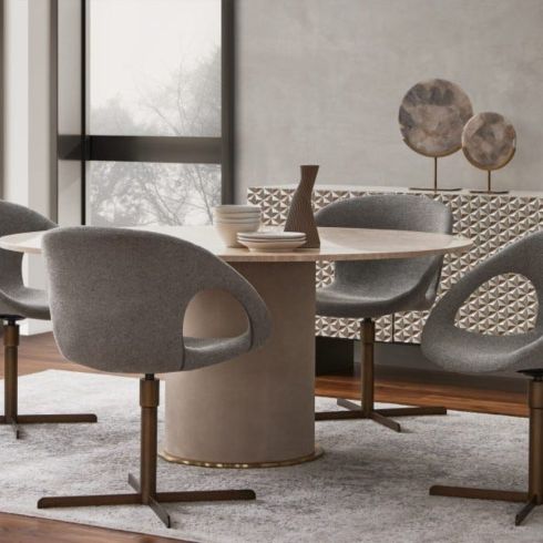 A neutral-coloured dining room table with four modern chairs