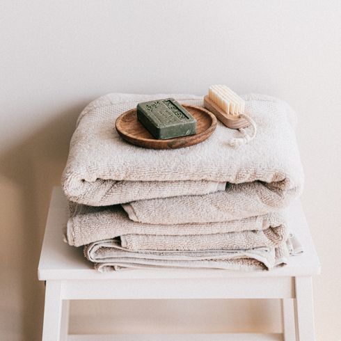 a stack of towels and bath accessories