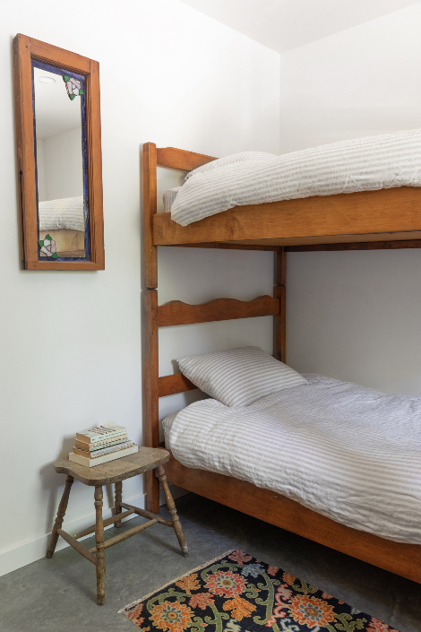 A bedroom with wooden bunk beds