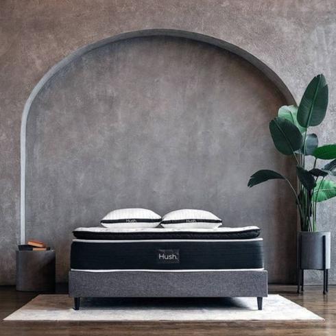 A Hush bed in a bedroom with an arch grey detail