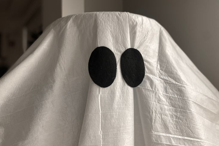A white sheet covering a Halloween stand