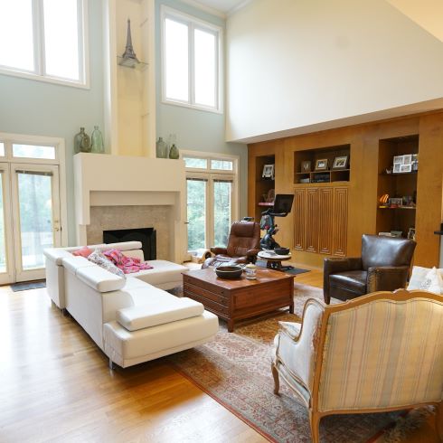 Living room with high ceilings and windows