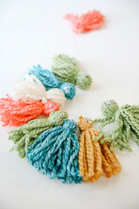 colourful yarn garland with googly eyes 