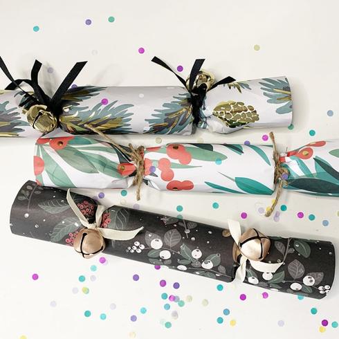 Three holiday crackers made out of giftwrap.