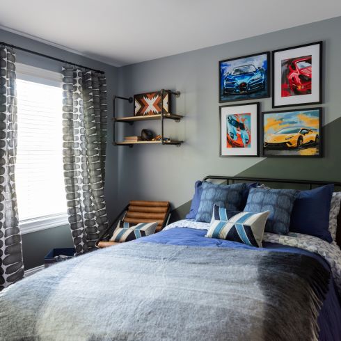 Two tone grey boys bedroom with pictures of cars on the wall