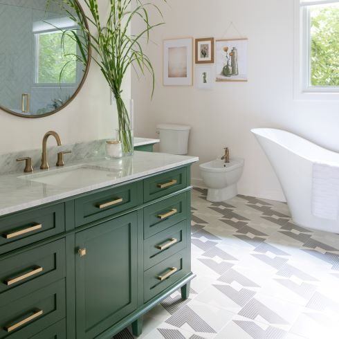 Green bathroom cabinets with unique patterned tile floor