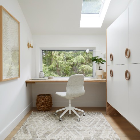 Office with a large window to the woods
