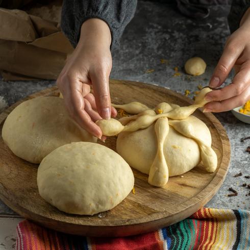 How to Celebrate Dia de Muertos- personPerson making bread of the dead