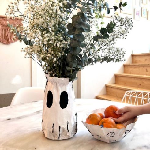 Ghost shaped paper mache vase holding flowers