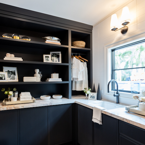 The Baeumler's new laundry room with dark shelving and cabinetry