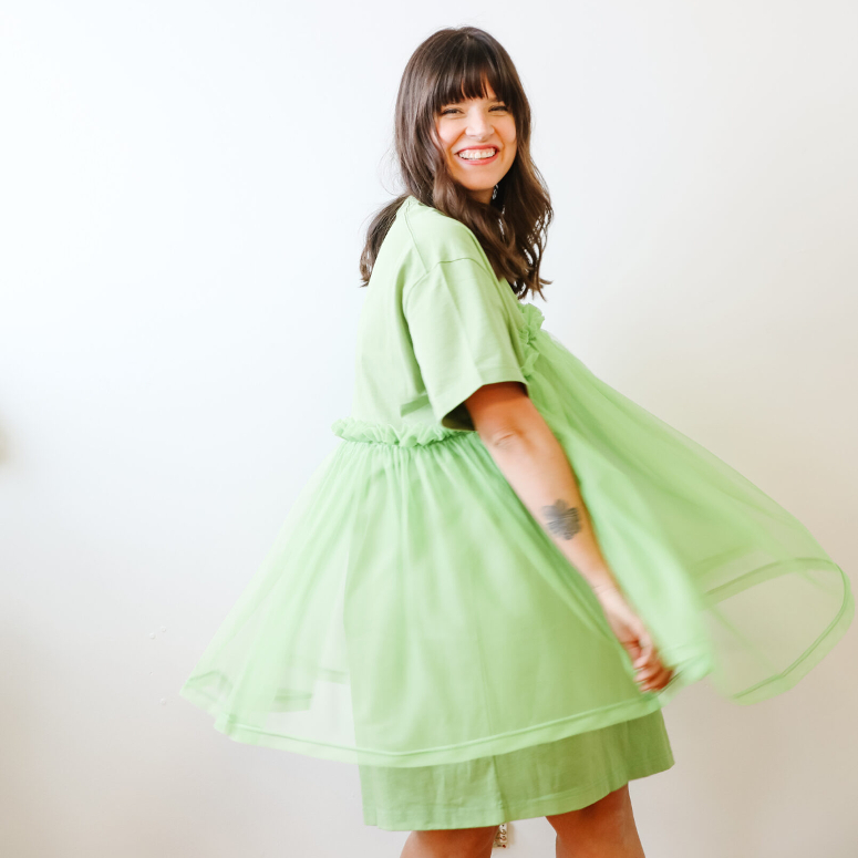 Blogger Maca Atencio twirls in a green dress