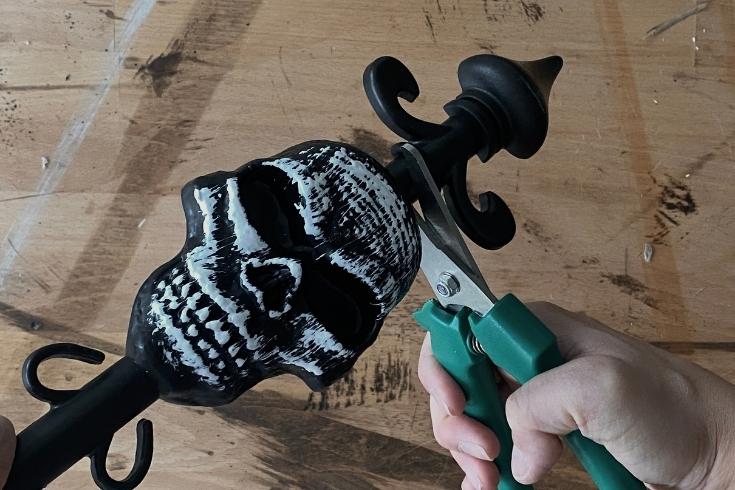 Person cutting plastic skull stake 