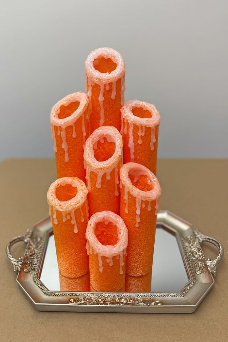pool noodles centred on mirrored plate with hot glue