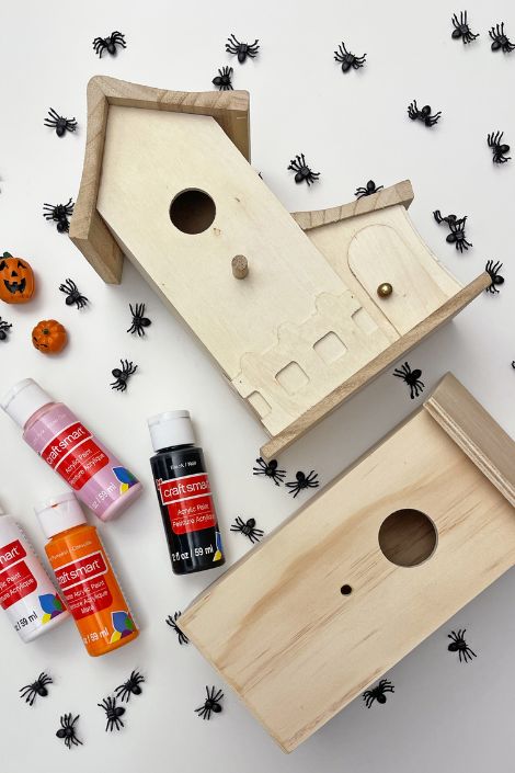 bird house with paint and bat-themed stickers