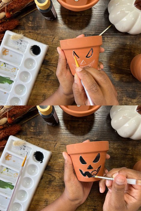Two photos of a person's hands outlining and filling jack-o-lantern features on terracotta pot with black paint.