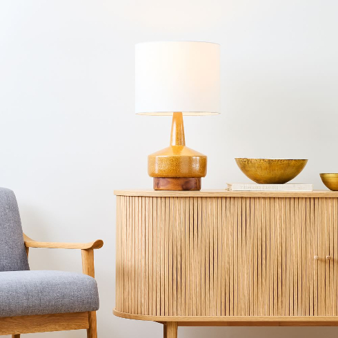 A wooden and ceramic table lamp