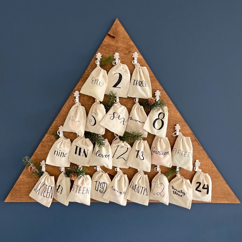 DIY Wooden Advent Calendar hung up on a blue wall