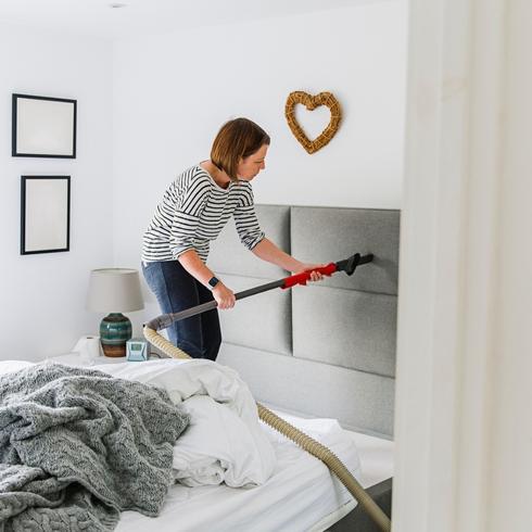 Woman cleaning her headboard