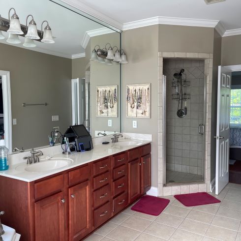 Dated bathroom with dark, enclosed shower