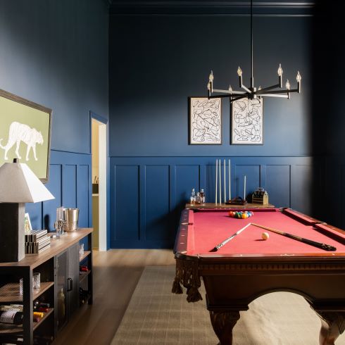 Billiards room with rich blue walls and modern trim work