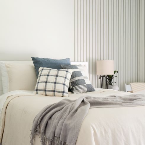 White bedroom with vertical slat feature wall