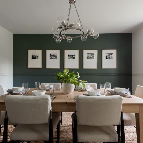 Elegant dining room with dark green accent wall