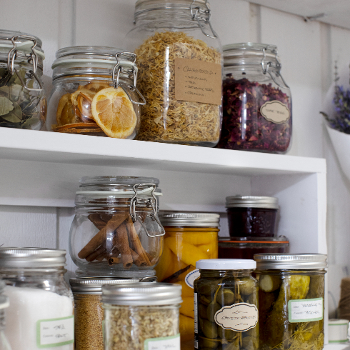 A close-up shot of various jars in the pantry area of Pamela Anderson's renovated basement