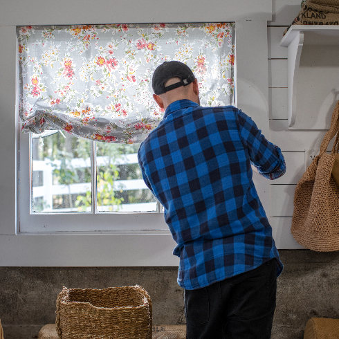 Pamela's assistant Jonathan hangs the DIY window treatments