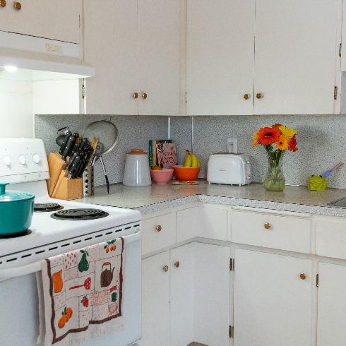 The details of the kitchen counter including vintage pyrex containers and more