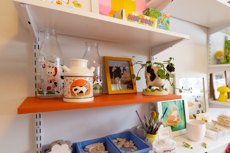 Close-up shot of cow-themed ceramics and collectibles in Meghan's home office