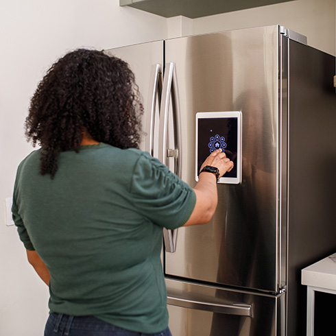 Person using a smart fridge - future home trends