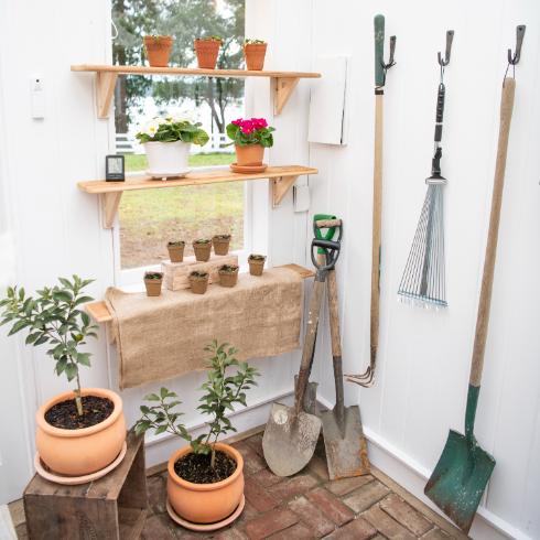 A shot of the potting area with various garden tools and antique brick flooring