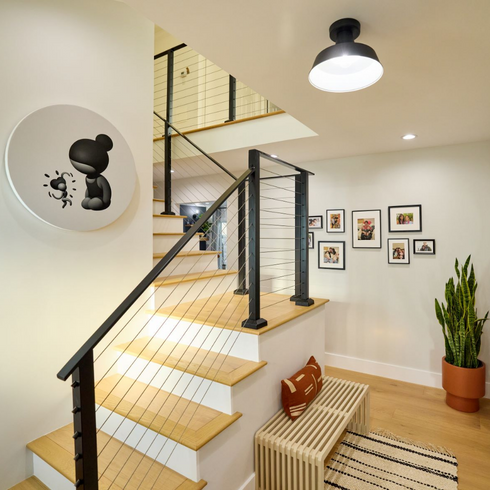 Bright and modern staircase with black and white art and a gallery wall