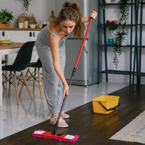 Woman cleaning floors with a red mop